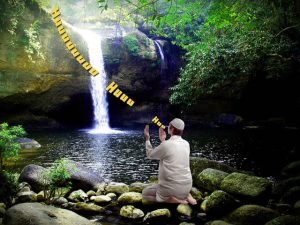 man chanting near waterfall