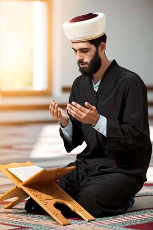 Turkish Muslim Man making dua, reading Quran