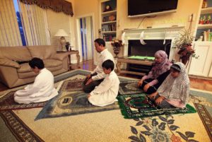 muslim family praying together at home. salah, namaz