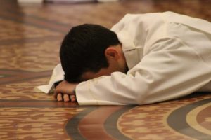 person with face to floor, sajda, sujood, prostration,