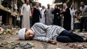Boy laying unconscious on ground surrounded by people